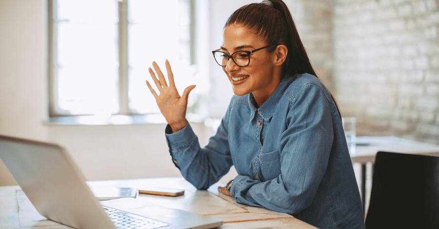 Woman on virtual call, waving