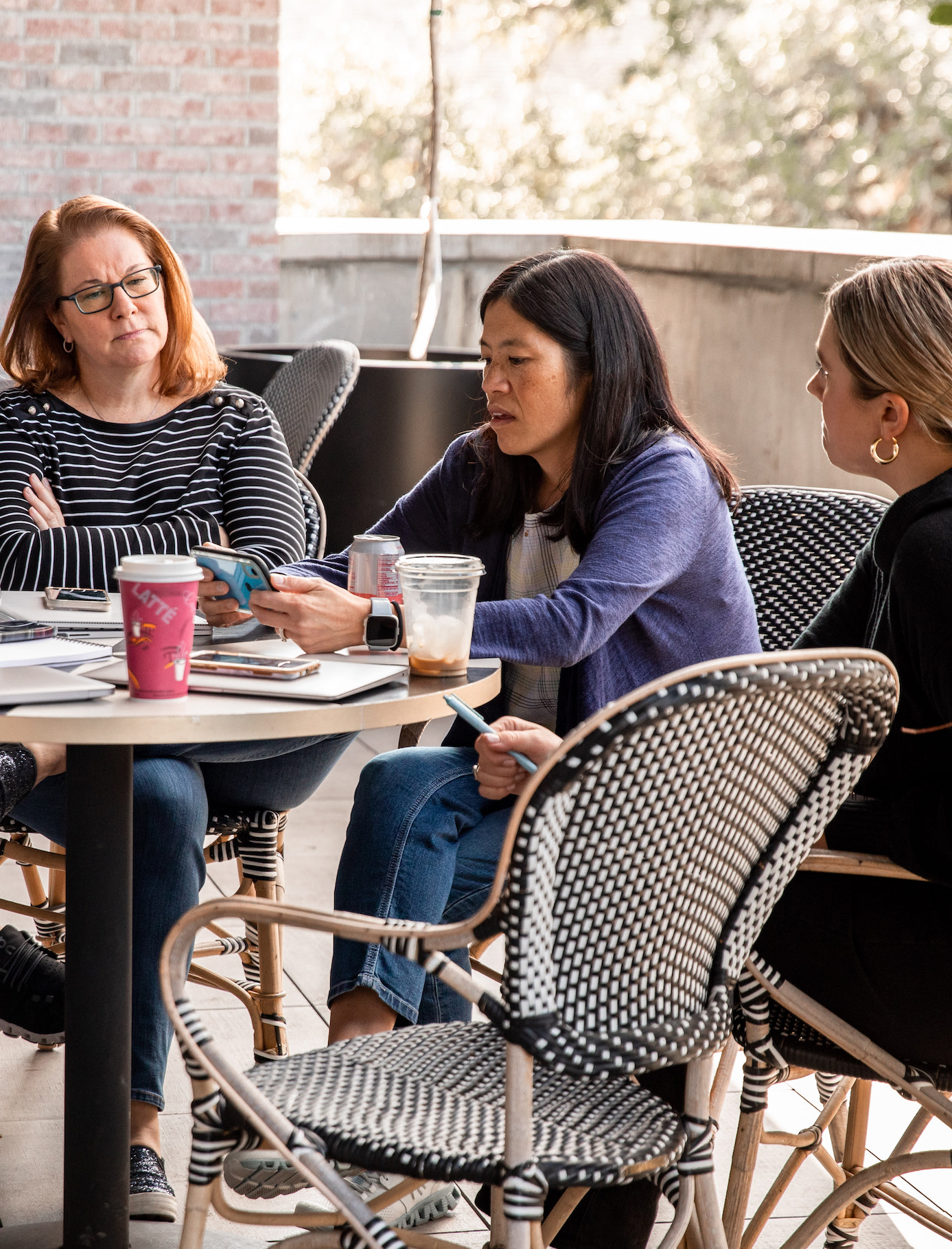 Three Team Members Outside at Table